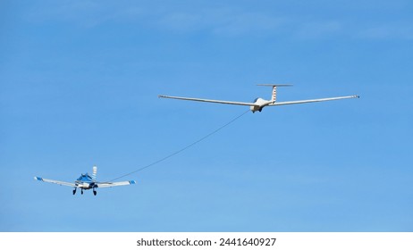 small plane towing glider sailboat fountainmilanos aeroclub background blue sky - Powered by Shutterstock