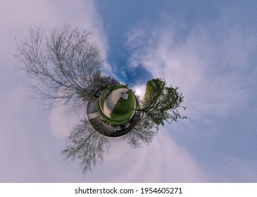 Small Planet Of A Park With Very Cloudy And White Sky. Little Planet