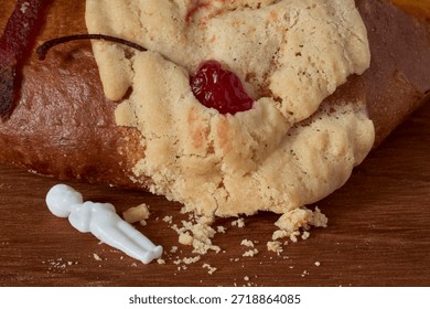 The small plastic figurine outside the bread symbolizes the good fortune of whoever will be hosting the tamales.