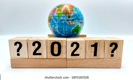 Small Plastic Globe On Top Of Wooden Blocks To Present The Global Uncertainty In 2021