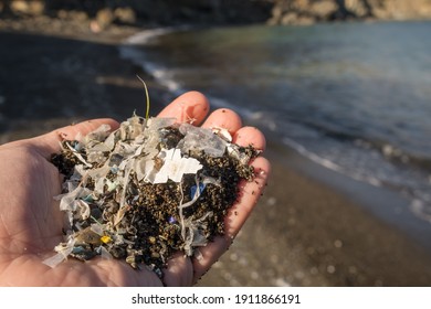 Small plastic parts and microplastics on the sand beach. Global ocean pollution. Microplastic in water and food. Global ocean pollution. Microplastic environment problem.
