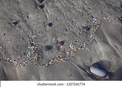 Small plastic parts and microplastics in the sand of Famara beach, Lanzarote, Spain.