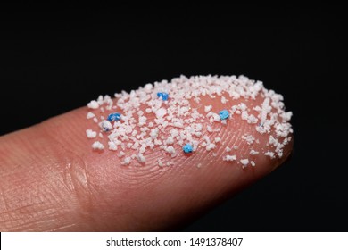Small Plastic pellets on the finger.Micro plastic.air pollution