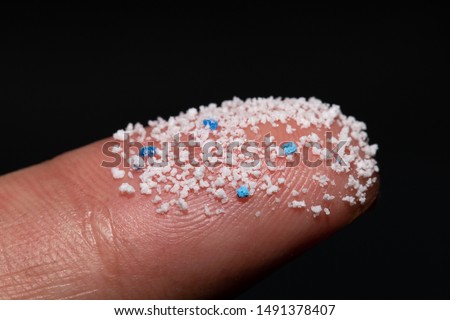 Small Plastic pellets on the finger.Micro plastic.
air pollution