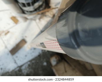 
a small plastic pipe is being installed