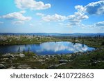 Small pond reflecting blue sky and white clouds on SÃ¤rkitunturi fell top in Muonio, Lapland, Finland