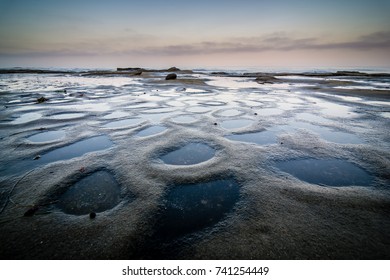 Small pools of water along the La Jolla tide pools in San Diego, California