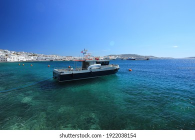 Small Power Boat Moored Off The Coast Of Mykonos In Greece