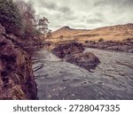 Small and powerful river Erriff in county Galway, Ireland. Connemara area. Rough stream with rocks, waterfall and mountains in the background. Irish nature scene. Popular travel area.