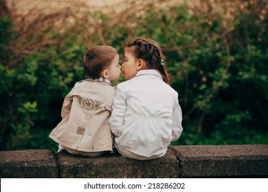 Small and pretty child fell lovely and happy it`s  first kiss