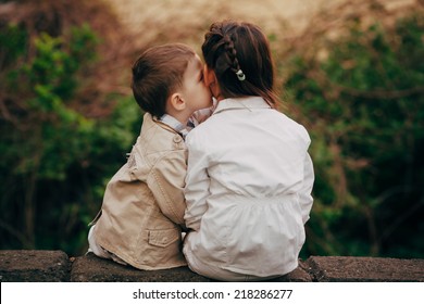Small and pretty child fell lovely and happy it`s  first kiss