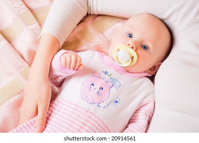 Small pretty child lying by her mother