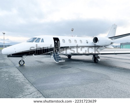 Small private business jet at airport parking ready for departure