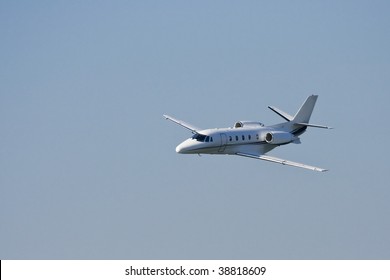 Small Private Jet Landing Or Taking Off With Background Of Blue Sky