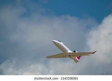 Small Private Jet Taking Off At Airport Runway