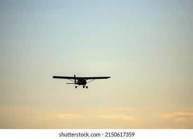 Small Private Red Propeller Plane Flies In The Sky