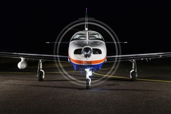 Small Private Single-engine Piston Aircraft On Runway, Front View, Night Photo