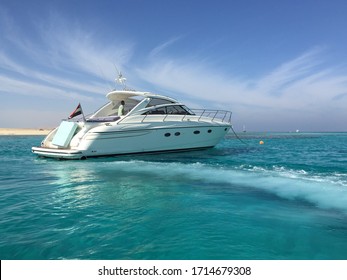 Small private yacht in the sea with beautiful turquoise wave and lightly stretched clouds