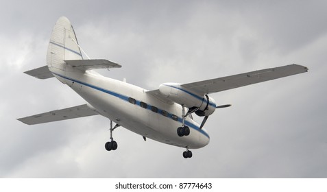 small propeller aircraft in cloudy back, with clipping path