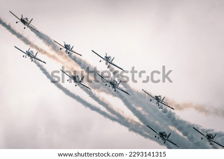 Small propeller aircraft flying in formation for airshow