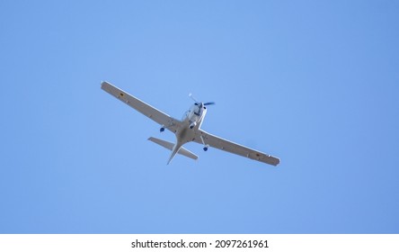 Small Propeller Plane Flies Against The Clear Sky During The Day