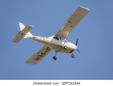 Small Propeller Plane Flies Against The Clear Sky During The Day