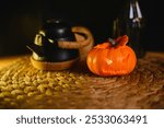 A small pumpkin for Halloween, candles and a Jolly Roger mask