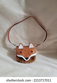 A Small Purse In The Shape Of A Fox