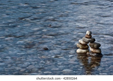 small pyramide made of stones in a river