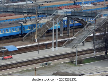 Small Railway Station With Passenger Train Cars On The Tracks Aerial Stock Photo