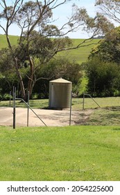 Small Rain Water Tank Made Out Of Tin On A Cement Platform