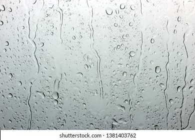 A small raindrop rests on the glass after rain. - Shutterstock ID 1381403762