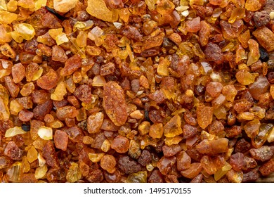 Small Raw Amber On A Wooden Table. A Precious Find From The Coast Of Central Europe. Light Background.