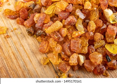 Small Raw Amber On A Wooden Table. A Precious Find From The Coast Of Central Europe. Light Background.