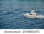 A small recreation boat in the blue Bahamas waters. Fishing charter or pleasure ride recreation for the family simple and wholesome activity.