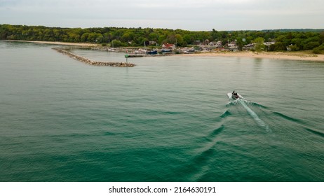 Small recreational fishing boat coming into the Leland harbor on Lake Michigan