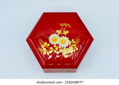 A Small Red Box Souvenir With A Hexagonal Floral Pattern