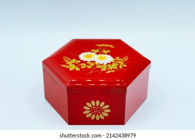 A Small Red Box Souvenir With A Hexagonal Floral Pattern