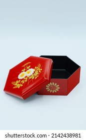 A Small Red Box Souvenir With A Hexagonal Floral Pattern