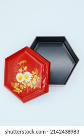 A Small Red Box Souvenir With A Hexagonal Floral Pattern