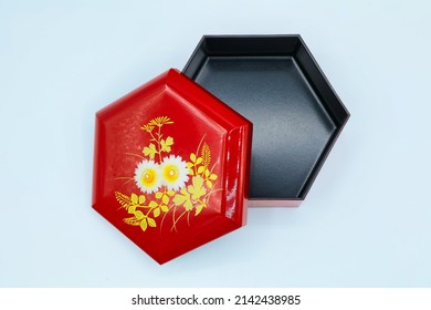 A Small Red Box Souvenir With A Hexagonal Floral Pattern