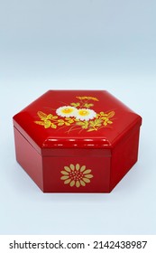 A Small Red Box Souvenir With A Hexagonal Floral Pattern