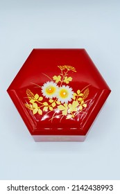 A Small Red Box Souvenir With A Hexagonal Floral Pattern