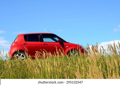 Small Red Car At Meadow