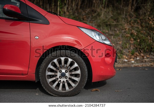 Small red city\
utility car, side detail\
wheel