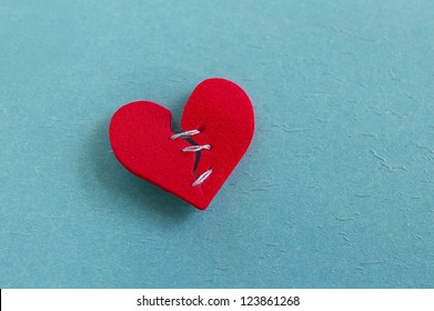 Small Red Heart, Broken With Threaded Stitches