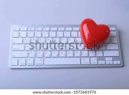 Small red heart on keyboard. Internet dating concept
