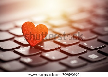 Small red heart on keyboard. Internet dating concept. 