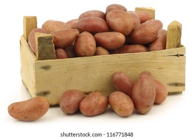 Small Red Potatoes In A Wooden Crate On A White Background