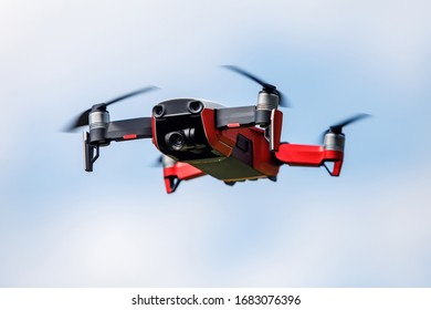 Small red quadrocopter in the air